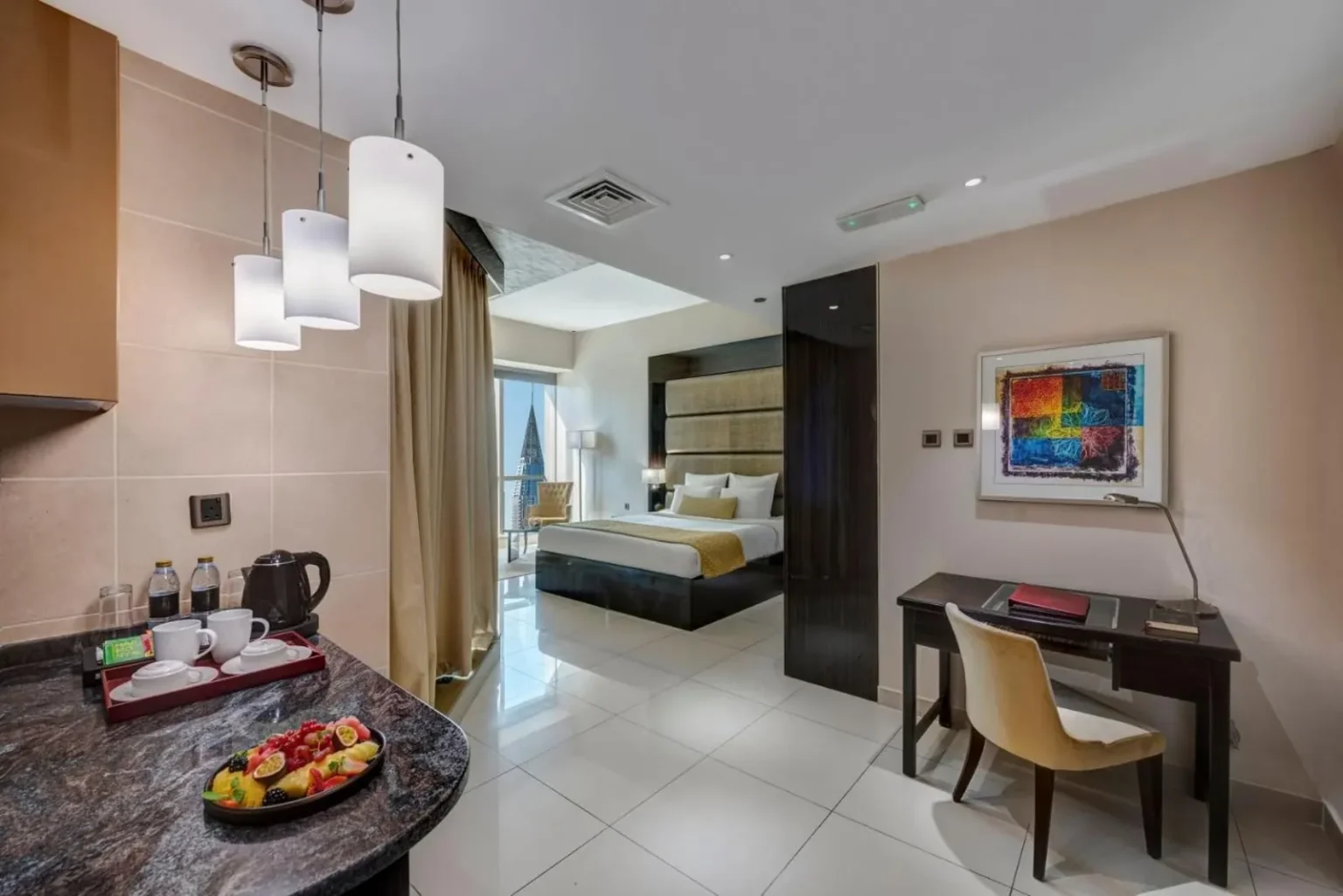 Deluxe Room at Gevora Hotel Dubai with king bed, work desk and tea and coffee station