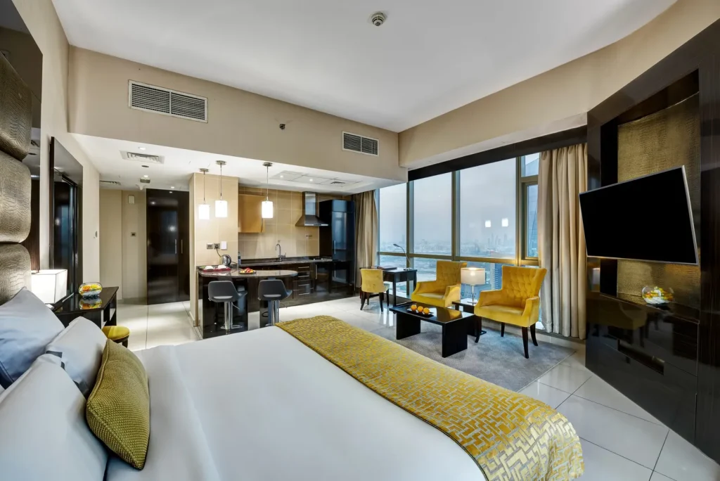 Guest room with king bed and seating area by the window, Gevora Hotel