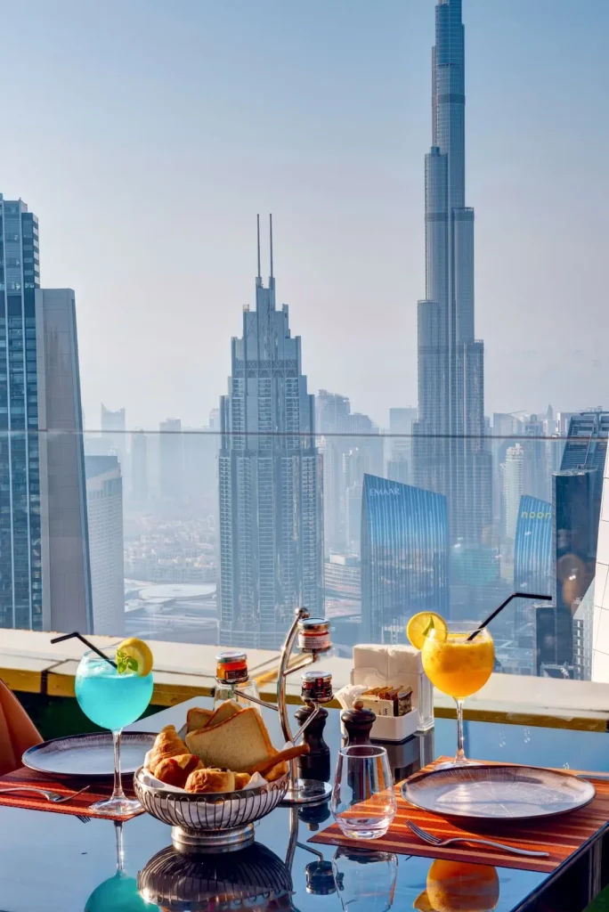 Mocktails and bread basket on a Highest View table with Burj Khalifa behind, Gevora Hotel Dubai