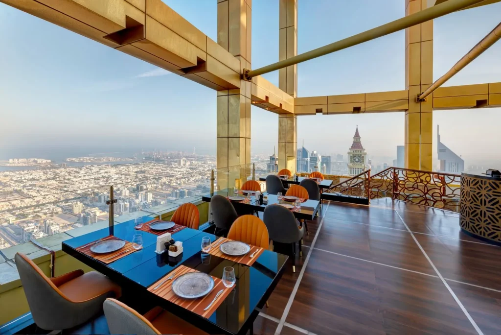 Highest View Lounge & Restaurant tables beside floor-to-ceiling windows high above Dubai