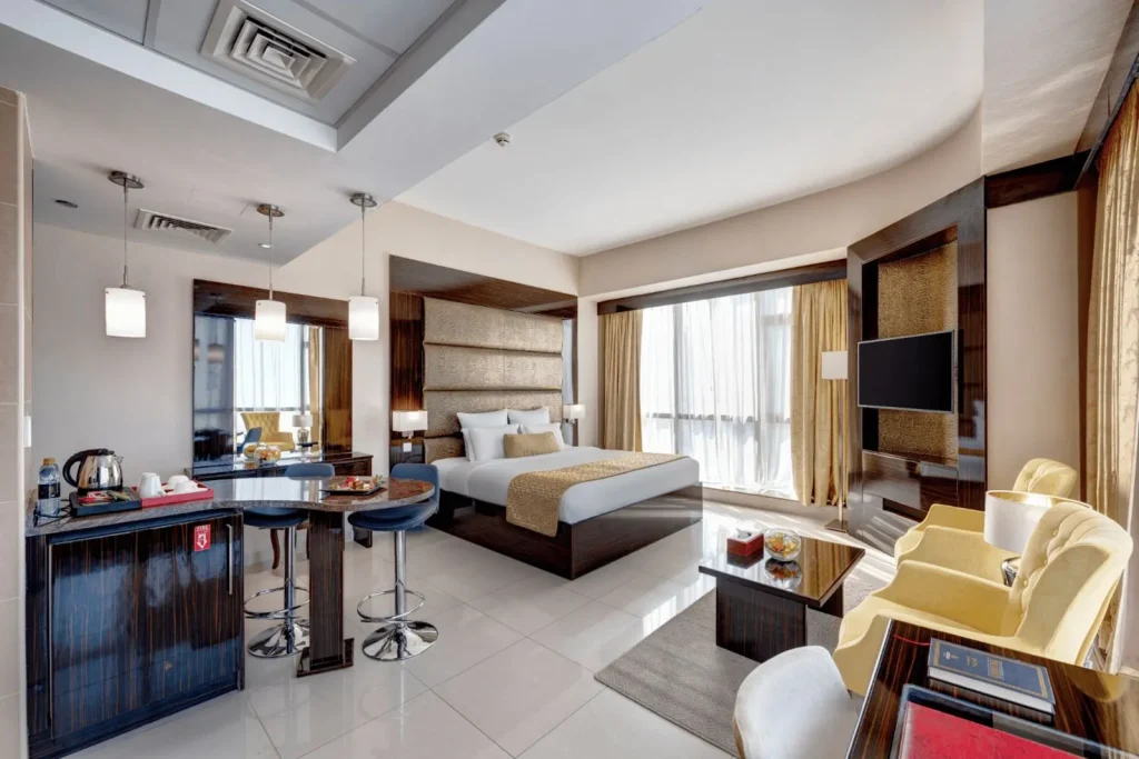 Guest room with king bed, sofa and kitchenette counter, Gevora Hotel