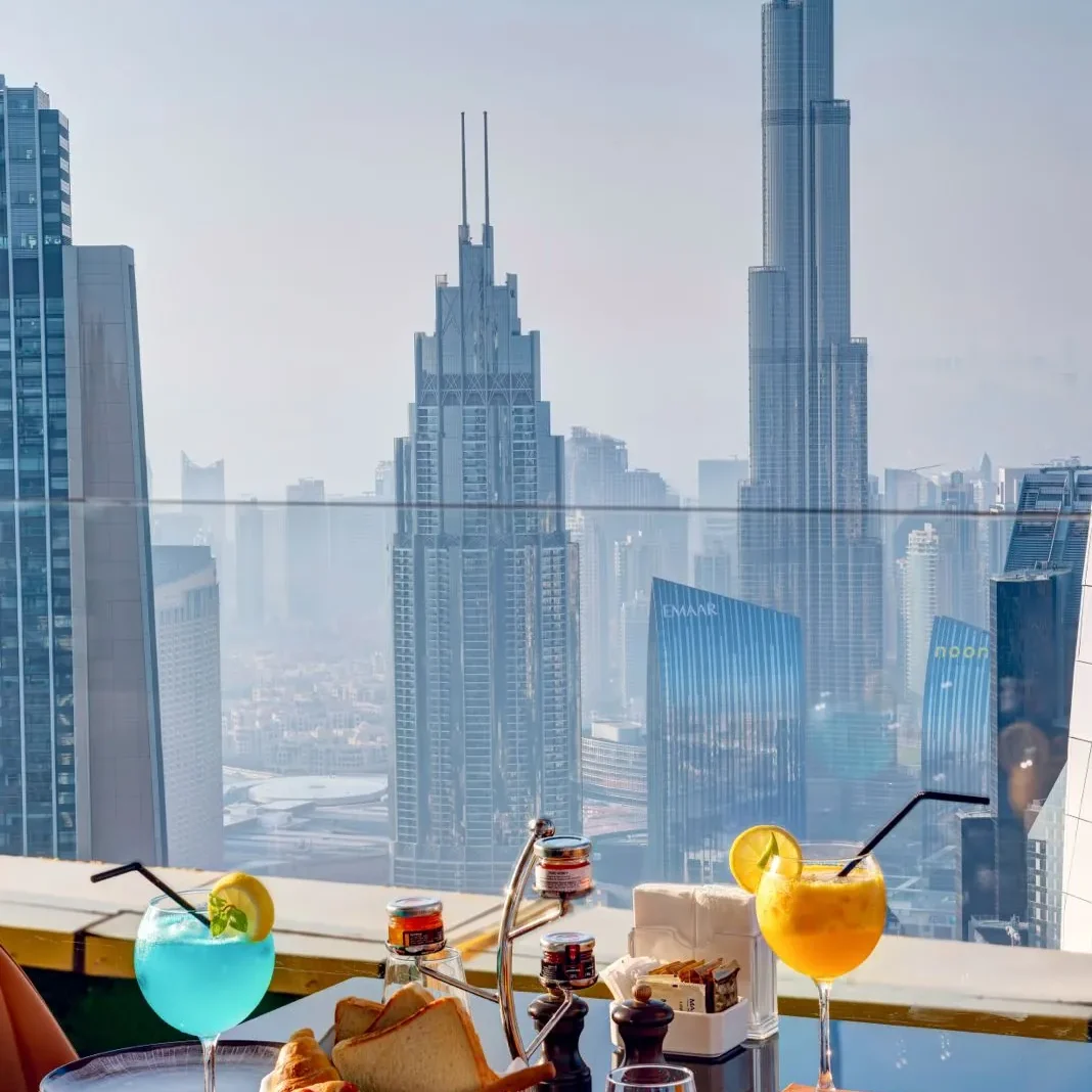 Mocktails and bread basket on a Highest View table with Burj Khalifa behind, Gevora Hotel Dubai