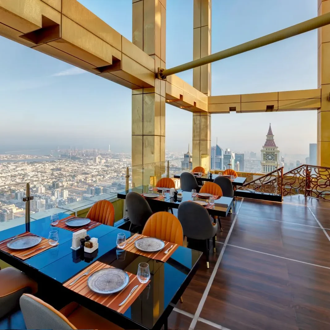 Highest View Lounge & Restaurant tables beside floor-to-ceiling windows high above Dubai