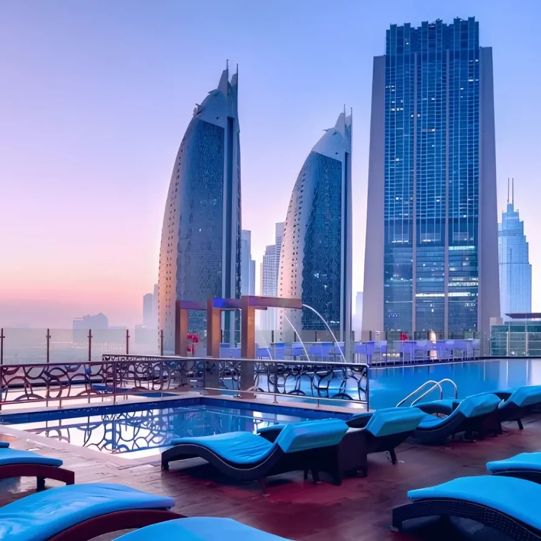 Overview Pool Lounge pool deck with sun loungers and the Sheikh Zayed Road skyline at sunset